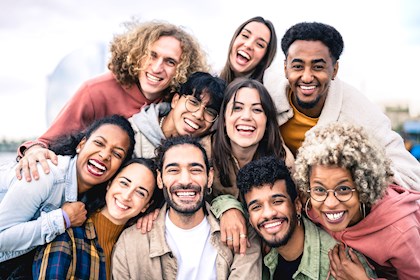 Diverse group of people huddled in a group