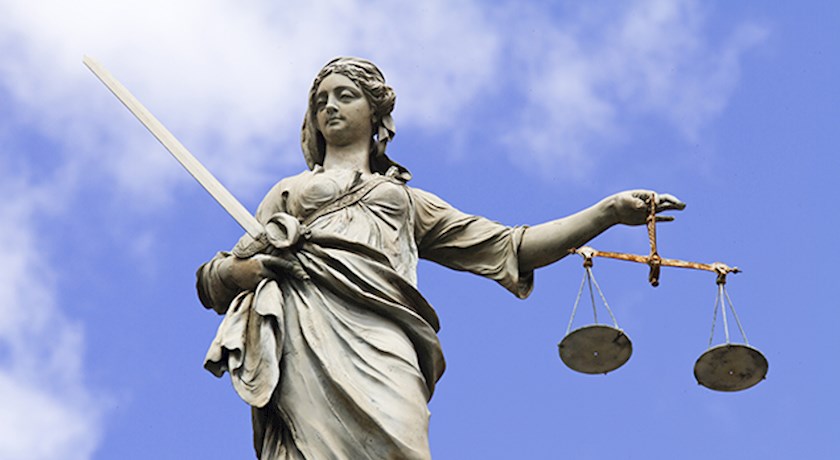 Image of Lady Justice on blue sky background