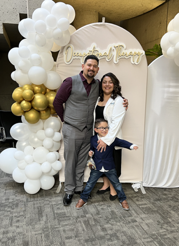 OTD student Cristyn Amaral pictured with her spouse Ramon and her son Xavier at a white coat ceremony.