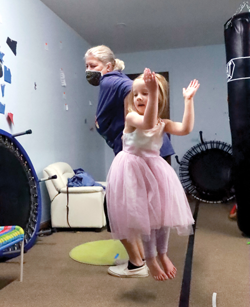 Child and grandmother learn and perform "The Macarena" dance to address skills related to bilateral coordination, balance, memory, and crossing midline.